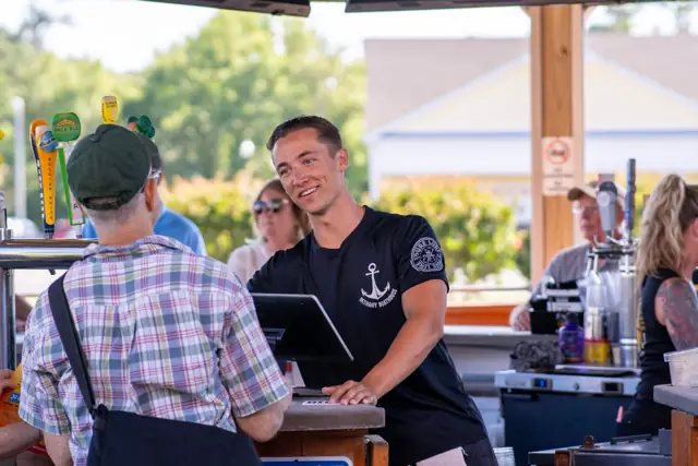 Bartender chatting with a guest at the outdoor bar